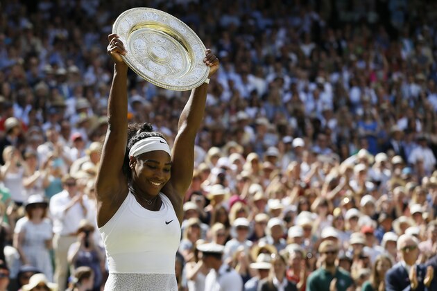 Serena Williams of the United States holds up the trophy after winning the women's singles final against Garbine Muguruza of Spain, at the All England Lawn Tennis Championships in Wimbledon, London, Saturday July 11, 2015. (AP Photo/Kirsty Wigglesworth)