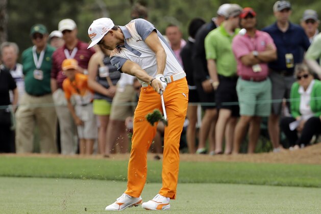 Rickie Fowler hits on the first fairway during the fourth round of the Masters golf tournament Sunday, April 12, 2015, in Augusta, Ga. (AP Photo/David J. Phillip)