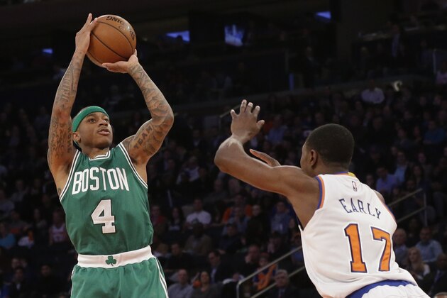 Boston Celtics guard Isaiah Thomas (4) shoots a 3-point goal past New York Knicks forward Cleanthony Early (17) during the second half of an NBA basketball game, Friday, March 27, 2015, at Madison Square Garden in New York. The Celtics won 96-92. (AP Photo/Mary Altaffer)