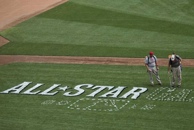 Workers prepare the field at Great American Ball Park for the 2015 All-Star Game Baseball game, Thursday, July 9, 2015, in Cincinnati. The city is preparing for a weekend of events in the lead-up to the July 14 game. (AP Photo/John Minchillo)