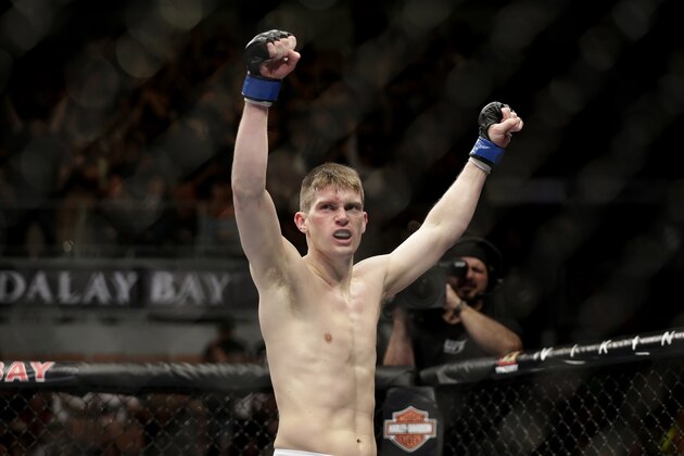 Stephen Thompson celebrates his TKO win over Robert Whittaker following a UFC 170 mixed martial arts welterweight fight on Saturday, Feb. 22, 2014, in Las Vegas. (AP Photo/Isaac Brekken)