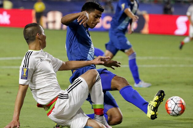 Mexico defender Paul Aguilar, left, gets the ball kicked away by Guatemala defender Moises Hernandez, right, during the second half of a CONCACAF Gold Cup soccer match Sunday, July 12, 2015, in Glendale, Ariz.  The game ended in a 0-0 tie. (AP Photo/Ross D. Franklin)