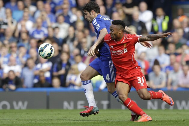 Chelsea's Cesc Fabregas, left, vies for the ball with Liverpool's Raheem Sterling during their English Premier League soccer match between Chelsea and Liverpool at Stamford Bridge stadium in London, Sunday, May 10, 2015. (AP Photo/Matt Dunham)