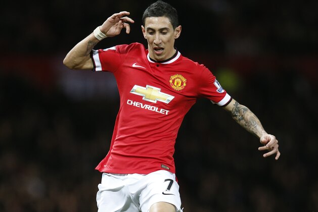 Manchester United’s Angel Di Maria runs with the ball during the English FA Cup quarterfinal soccer match between Manchester United and Arsenal at Old Trafford Stadium, Manchester, England, Monday March 9, 2015. (AP Photo/Jon Super)