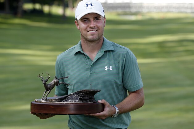 Jordan Spieth poses with the John Deere Classic trophy after winning the tournament by defeating Tom Gillis on the second playoff hole Sunday, July 12, 2015, in Silvis, Ill. (AP Photo/Charles Rex Arbogast)