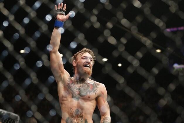 Conor McGregor celebrates between rounds against Chad Mendes during their interim featherweight title mixed martial arts bout at UFC 189 on Saturday, July 11, 2015, in Las Vegas. (AP Photo/John Locher)