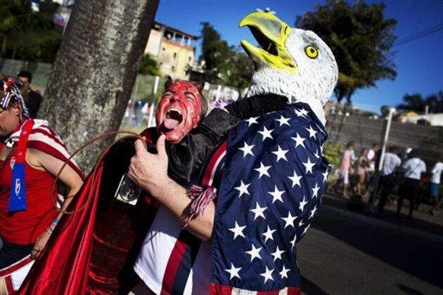 In this Tuesday, July 1, 2014 photo, a U.S. soccer fan wearing a bald eagle mask cheers with a Belgium fan before the start of a World Cup round of 16 match between the USA and Belgium, in Salvador, Brazil. Belgium held to beat the USA 2-1 in extra time. (AP Photo/Rodrigo Abd)