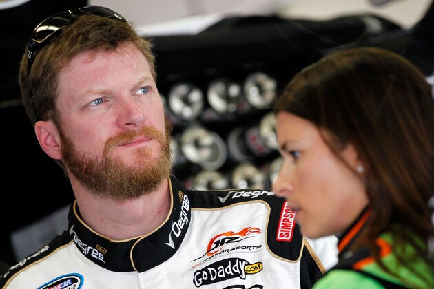 Dale Earnhardt Jr., and Danica Patrick talk before qualifying for Sunday's  NASCAR Sprint Cup Series auto race at Talladega Superspeedway Saturday, Oct. 18, 2014, in Talladega, Ala.  (AP Photo/Rainier Ehrhardt)