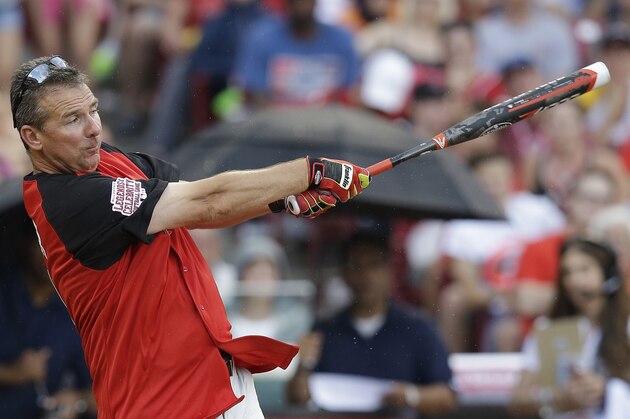 Ohio State coach Urban Meyer hits during the All-Star Legends & Celebrity Softball game, Sunday, July 12, 2015, in Cincinnati. (AP Photo/John Minchillo)