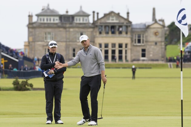 With the clubhouse in the background Jordan Spieth of the United States reacts after playing a shot on the first green during a practice round at St Andrews Golf Club prior to the start of the British Open Golf Championship, in St. Andrews, Scotland, Monday, July 13, 2015. (AP Photo/Jon Super)