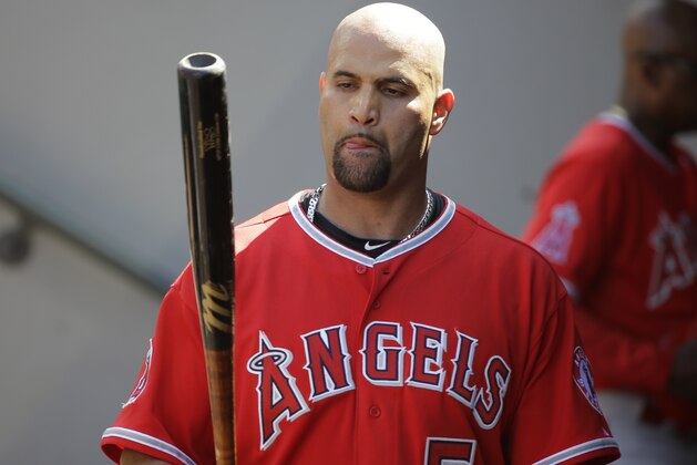 Los Angeles Angels' Albert Pujols stands in the dugout during a baseball game against the Seattle Mariners, Sunday, July 12, 2015, in Seattle. (AP Photo/Ted S. Warren)