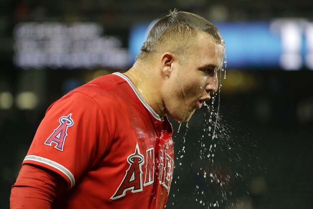 Los Angeles Angels' Mike Trout recovers after teammate Albert Pujols poured ice water on him during a post-game interview after Trout hit two home runs to lead the Angels to a 7-3 win over the Seattle Mariners in a baseball game, Friday, July 10, 2015, in Seattle. (AP Photo/Ted S. Warren) Los Angeles Angels' Mike Trout recovers after teammate Albert Pujols poured ice water on him during a post-game interview after Trout hit two home runs to lead the Angels to a 7-3 win over the Seattle Mariners in a baseball game, Friday, July 10, 2015, in Seattle. (AP Photo/Ted S. Warren)
