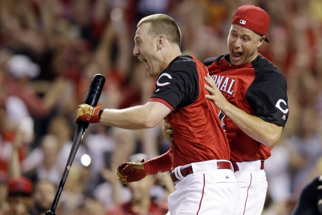 National League's Todd Frazier, left, of the Cincinnati Reds, reacts after winning the MLB All-Star baseball Home Run Derby, Monday, July 13, 2015, in Cincinnati. (AP Photo/John Minchillo)