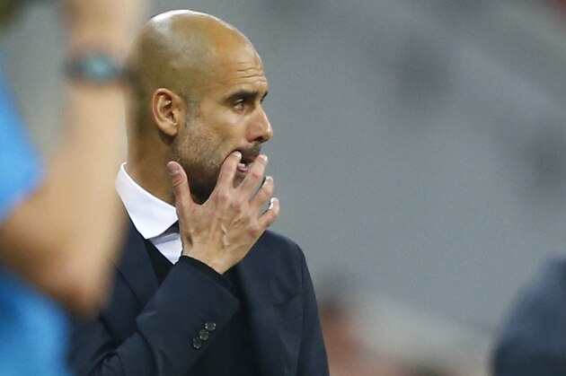 Bayern's head coach Pep Guardiola watches the soccer Champions League second leg semifinal match between Bayern Munich and FC Barcelona at Allianz Arena in Munich, southern Germany, Tuesday, May 12, 2015. (AP Photo/Matthias Schrader)