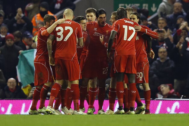 Liverpool players celebrate their equalizing goal against Chelsea during the English League Cup semi-final first leg soccer match between Liverpool and Chelsea at Anfield Stadium, Liverpool, England, Tuesday Jan. 20, 2015. (AP Photo/Jon Super)
