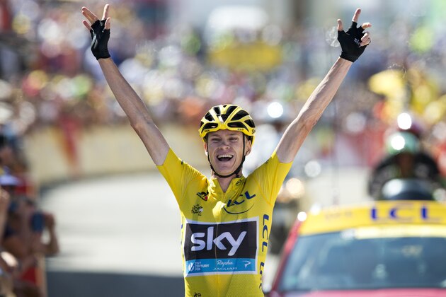 Britain's Christopher Froome, wearing the overall leader's yellow jersey, celebrates as he crosses the finish line to win the tenth stage of the Tour de France cycling race over 167 kilometers (103.8 miles) with start in Tarbes and finish in La Pierre-Saint-Martin, France, Tuesday, July 14, 2015. (AP Photo/Peter Dejong)