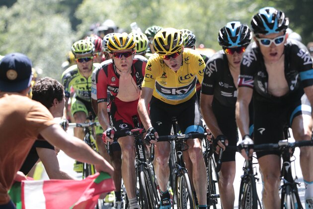 Tejay van Garderen of the U.S., left, follows team Sky with Britain's Christopher Froome, wearing the overall leader's yellow jersey, as they set the pace in the climb during the tenth stage of the Tour de France cycling race over 167 kilometers (103.8 miles) with start in Tarbes and finish in La Pierre-Saint-Martin, France, Tuesday, July 14, 2015. (AP Photo/Christophe Ena)