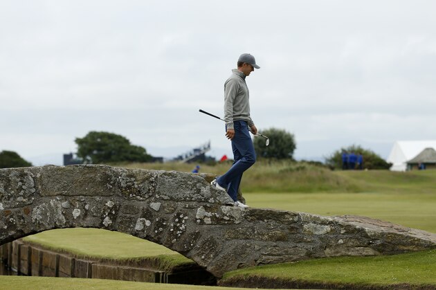 United States’ Jordan Spieth walks across Swilcan Bridge during a practice round at the British Open Golf Championship at the Old Course, St. Andrews, Scotland, Tuesday, July 14, 2015. (AP Photo/Jon Super)