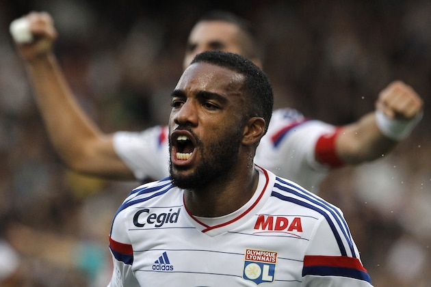Lyon's Alexandre Lacazette celebrates after he scored his second goal against Lille during their French League One soccer match in Lyon, central France, Sunday, Oct. 5, 2014. (AP Photo/Laurent Cipriani)