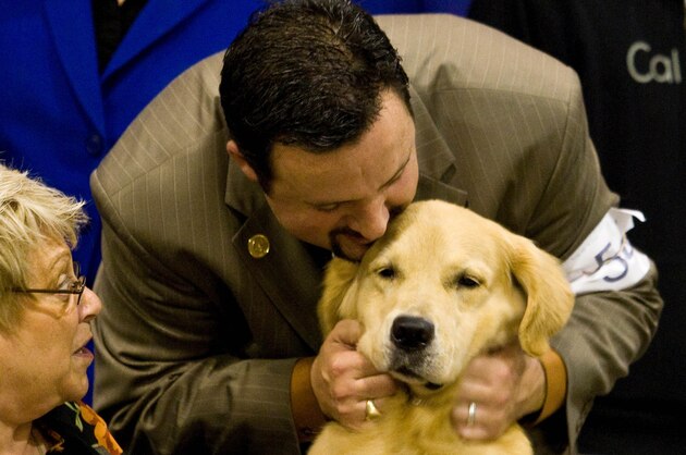 Dog show handler Clint Livingston shows his appreciation for a Golden Retriever named Champion of Toasty's Treasure Island who won the Reliant Park World Series of Dog Shows' Best in Show Sunday July 19, 2009 in Houston. Livingston is from Brighton, Colo. and