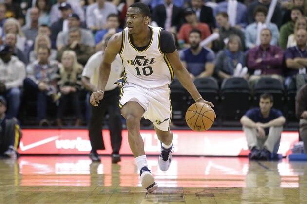 Utah Jazz's Alec Burks (10) brings the ball up court in the second half during an NBA basketball game against the Denver Nuggets Monday, Dec. 1, 2014, in Salt Lake City. (AP Photo/Rick Bowmer)