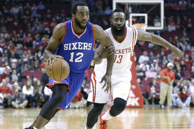 Houston Rockets' James Harden (13) tries to slow down Philadelphia 76ers' Luc Richard Mbah a Moute (12) in the first half of an NBA basketball game Friday, Nov. 14, 2014, in Houston. (AP Photo/Pat Sullivan)