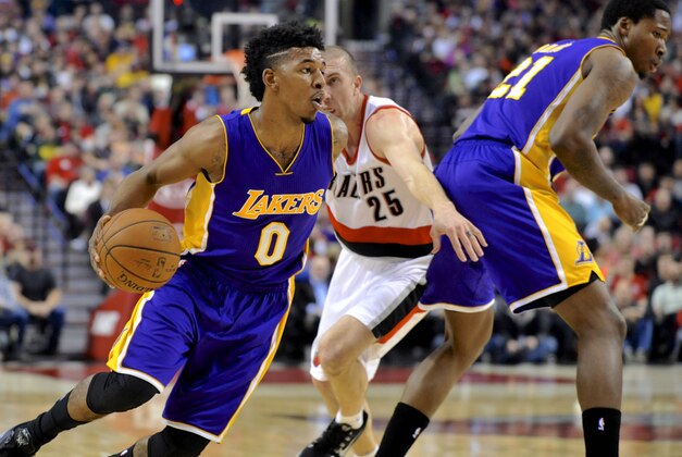 Portland Trail Blazers' Steve Blake (25) defends against Los Angeles Lakers' Nick Young (0) during the first half of an NBA basketball game in Portland, Ore., Wednesday Feb. 11, 2015. (AP Photo/Greg Wahl-Stephens)