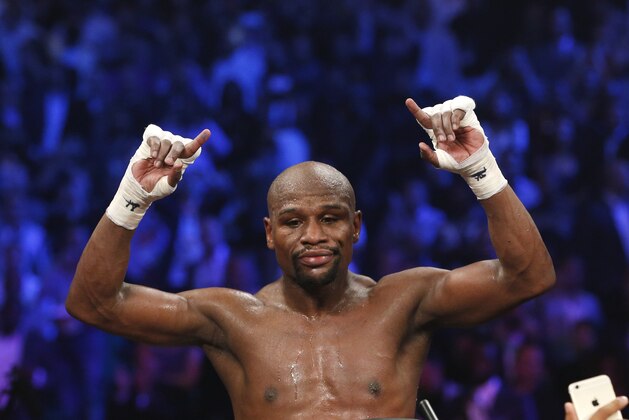 Floyd Mayweather Jr., celebrates his unanimous decision victory over Manny Pacquiao, from the Philippines, at the finish of their welterweight title fight on Saturday, May 2, 2015 in Las Vegas. (AP Photo/John Locher)