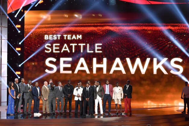 Russell Wilson and Seattle Seahawks accepts the award for best team at the ESPY Awards at the Nokia Theatre on Wednesday, July 16, 2014, in Los Angeles. (Photo by John Shearer/Invision/AP)