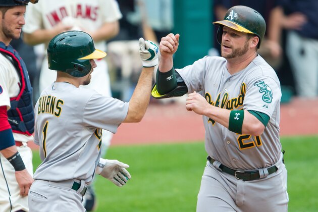 CLEVELAND, OH -  JULY 12: Billy Burns #1 and Stephen Vogt #21 of the Oakland Athletics celebrate after scoring on Vogt's home run in the fourth inning against the Cleveland Indians at Progressive Field on July 12, 2015 in Cleveland, Ohio. (Photo by Jason Miller/Getty Images)
