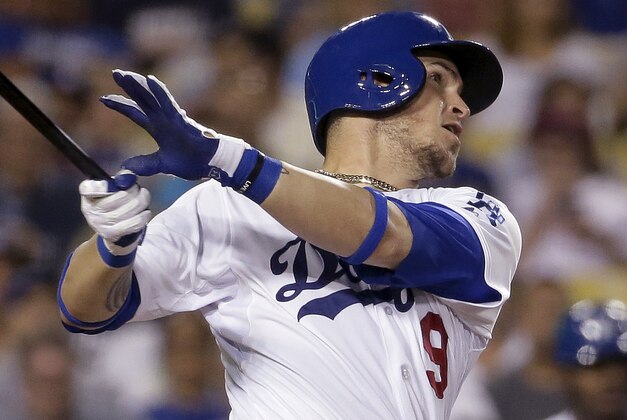 Los Angeles Dodgers' Yasmani Grandal watches his two-run home run against the Philadelphia Phillies during the sixth inning of a baseball game in Los Angeles, Tuesday, July 7, 2015. (AP Photo/Chris Carlson)