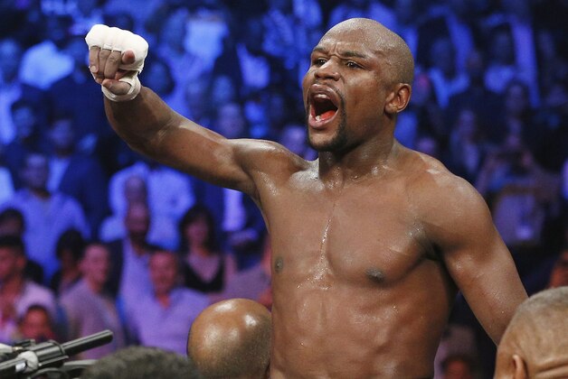 Floyd Mayweather Jr., celebrates his unanimous decision victory over Manny Pacquiao, from the Philippines, at the finish of their welterweight title fight on Saturday, May 2, 2015 in Las Vegas. (AP Photo/John Locher)