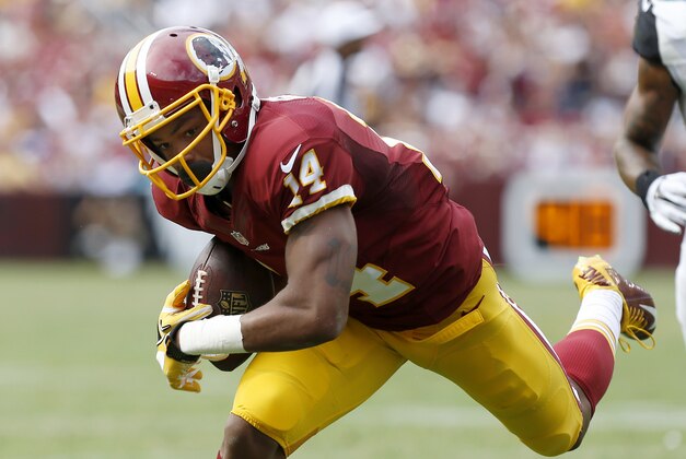 Sep 14, 2014; Landover, MD, USA; Washington Redskins wide receiver Ryan Grant (14) catches the ball against the Jacksonville Jaguars at FedEx Field. Mandatory Credit: Geoff Burke-USA TODAY Sports