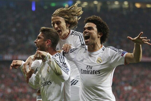Real's Sergio Ramos is congratulated by his teammates Luka Modric and Pepe, from left, as he celebrates scoring his side's 2nd goal during the Champions League semifinal second leg soccer match between Bayern Munich and Real Madrid at the Allianz Arena in Munich, southern Germany, Tuesday, April 29, 2014. (AP Photo/Matthias Schrader)