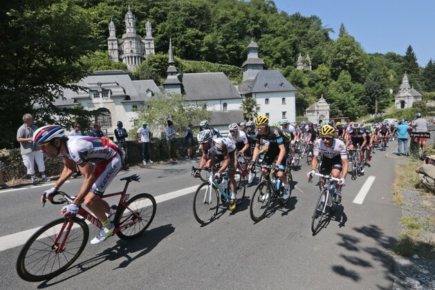 Spain's Alberto Losada leads the pack as they pass the Notre-Dame de Betharram sanctuary during the eleventh stage of the Tour de France cycling race over 188 kilometers (116.8 miles) with start in Pau and finish in Cauterets, France, Wednesday, July 15, 2015. (AP Photo/Christophe Ena)