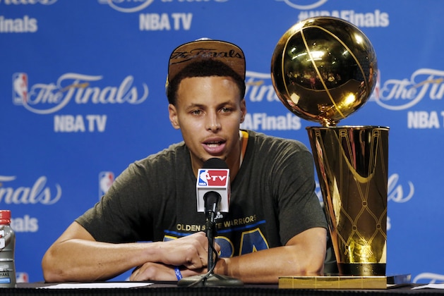Golden State Warriors guard Stephen Curry (30) responds to a question during a news conference following Game 6 of basketball's NBA Finals against the Cleveland Cavaliers, in Cleveland, Wednesday, June 17, 2015. The Warriors defeated the Cavaliers 105-97 to win the best-of-seven game series 4-2. (AP Photo/Paul Sancya)