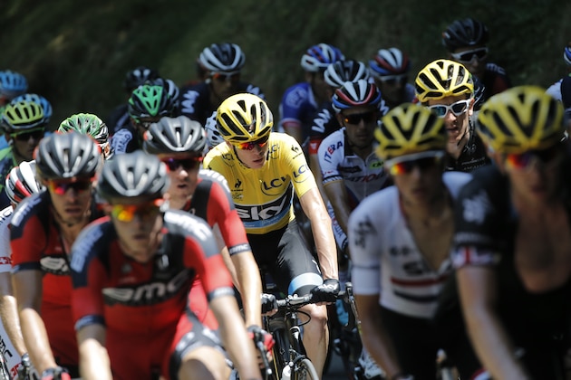 Britain's Christopher Froome, wearing the overall leader's yellow jersey, rides in the pack as they climb Aspin pass during the eleventh stage of the Tour de France cycling race over 188 kilometers (116.8 miles) with start in Pau and finish in Cauterets, France, Wednesday, July 15, 2015. (AP Photo/Laurent Cipriani)