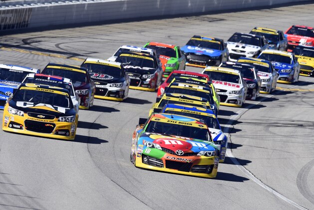 Kyle Busch (18) leads the field at the start of the NASCAR Sprint Cup series auto race at Chicagoland Speedway in Joliet, Ill., Sunday, Sept. 14, 2014. (AP Photo/Paul J. Bergstrom)