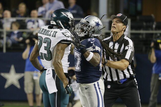Dallas Cowboys wide receiver Dwayne Harris scuffles with Philadelphia Eagles cornerback Nolan Carroll (23) while field judge Dave Meslow intervenes during the second half of an NFL football game, Thursday, Nov. 27, 2014, in Arlington, Texas. (AP Photo/Tony Gutierrez)