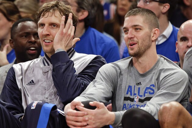 Dallas Mavericks' Dirk Nowitzki, left, Chandler Parsons, and Tyson Chandler, right, watch their team play during the second half of an NBA basketball game against the New York Knicks, Tuesday, Dec. 16, 2014, in New York. The Mavericks won 107-87. (AP Photo/Frank Franklin II)