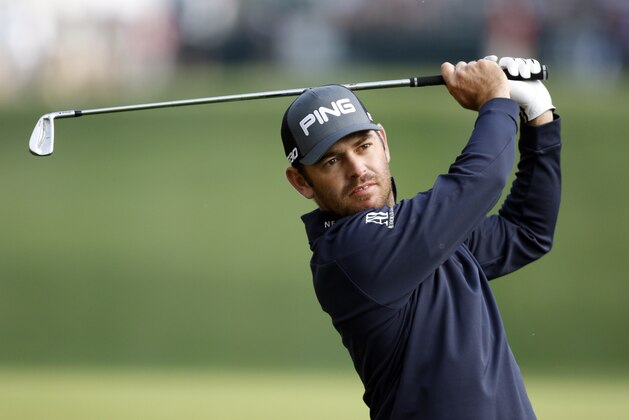 Louis Oosthuizen, of South Africa, watches his approach shot on the 10th hole during the first round of the Wells Fargo Championship golf tournament at Quail Hollow Club in Charlotte, N.C., Thursday, May 14, 2015. (AP Photo/Bob Leverone)