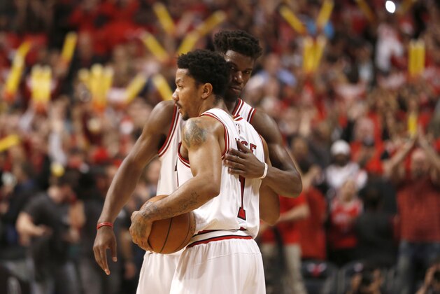 Chicago Bulls guard Derrick Rose (1) hugs Jimmy Butler after Game 2 of the NBA basketball playoffs against the Milwaukee Bucks Monday, April 20, 2015, in Chicago. The Bulls won 91-82. (AP Photo/Charles Rex Arbogast)