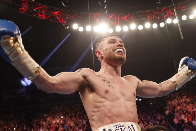 World champion Carl Frampton celebrates with after defeating Chris Avalos of the U.S. during the IBF super bantamweight world boxing title fight at the Odyssey arena, Belfast, Northern Ireland, Saturday, Feb. 28, 2015. (AP Photo/Peter Morrison)