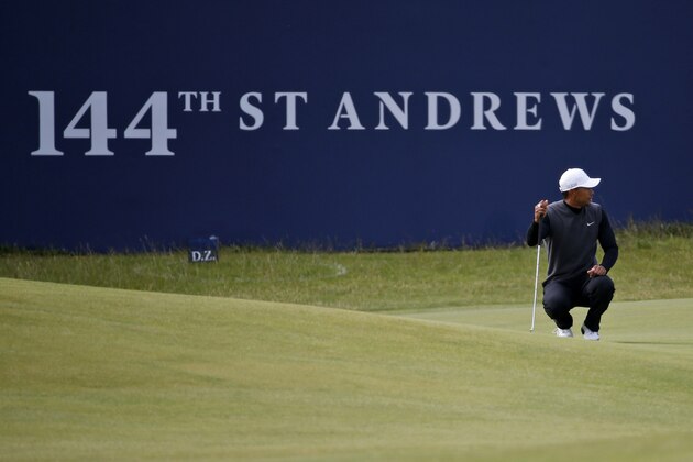 United States’ Tiger Woods lines up a play on hole one during a special Champion Golfers' challenge at the British Open Golf Championship at the Old Course, St. Andrews, Scotland, Wednesday, July 15, 2015. (AP Photo/Jon Super)