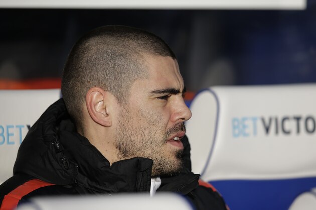 Manchester United's substitute goalkeeper Victor Valdes waits for the start of the English Premier League soccer match between QPR and Manchester United at Loftus Road stadium in London, Saturday, Jan. 17, 2015.  (AP Photo/Matt Dunham)