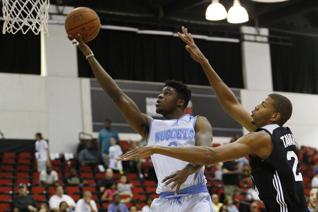 Denver Nuggets' Emmanuel Mudiay, left, goes up for a shot against the Atlanta Hawks' Walter Tavares during the first half of an NBA summer league basketball game Friday, July 10, 2015, in Las Vegas. (AP Photo/John Locher)