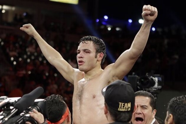 CORRECTS SPELLING OF FIRST NAME TO BRYAN - Julio Cesar Chavez Jr. celebrates in the ring after his victory over Bryan Vera of a 10-round boxing match between Chavez, the former World Boxing Council (WBC) middleweight champion, and Vera, the contender, in Carson, Calif., Saturday, Sept. 28, 2013. Chavez won in a unanimous decision. (AP Photo/Reed Saxon)