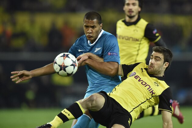 Dortmund's Sokratis of Greece, right, and Zenit's Jose Salomon Rondon, left, challenge for the ball during the UEFA Champions League last 16 second leg soccer match between Borussia Dortmund and FC Zenit in Dortmund, Germany, Wednesday, March 19, 2014.  (AP Photo/Martin Meissner)