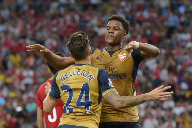 Arsenal's Chuba Akpom, right, embraces teammate Hector Bellerin after he scores against the Singapore Selection during their soccer match for the Barclays Asia Trophy in Singapore, Wednesday, July 15, 2015. (AP Photo/Joseph Nair)