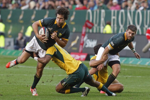 South Africa Jan Serfontein, left, is tackled  by Australia Tevita Kuridrani, second left, during a rugby championship game in Cape town, South Africa, Saturday, Sept. 27, 2014. (AP Photo/ Schalk van Zuydam)